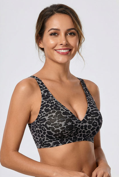 Woman wearing a leopard print bikini top against a plain background