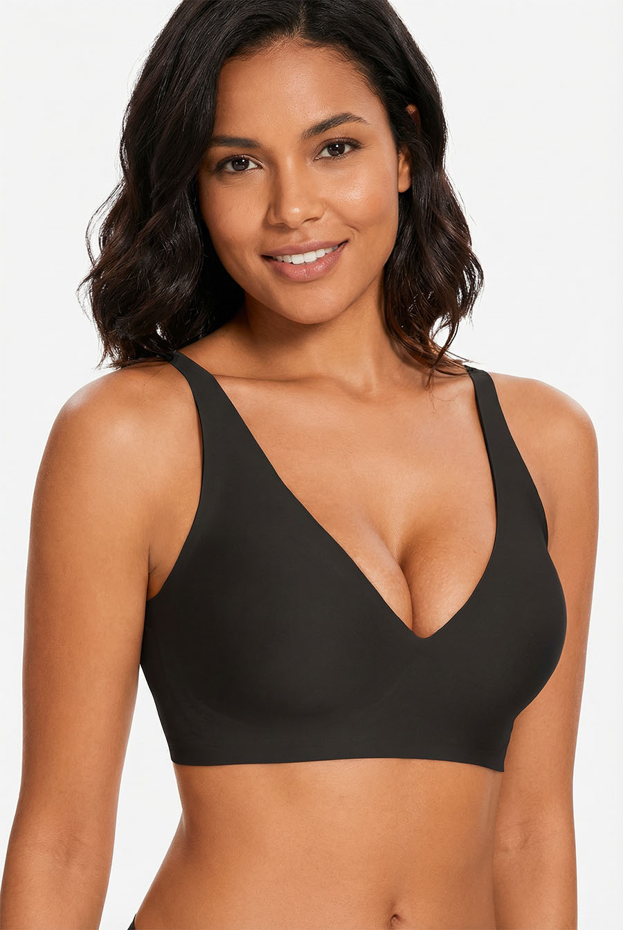 Woman wearing a black bralette against a white background