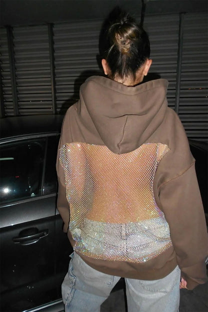 Person wearing a brown jacket with a reflective back panel in a car interior.