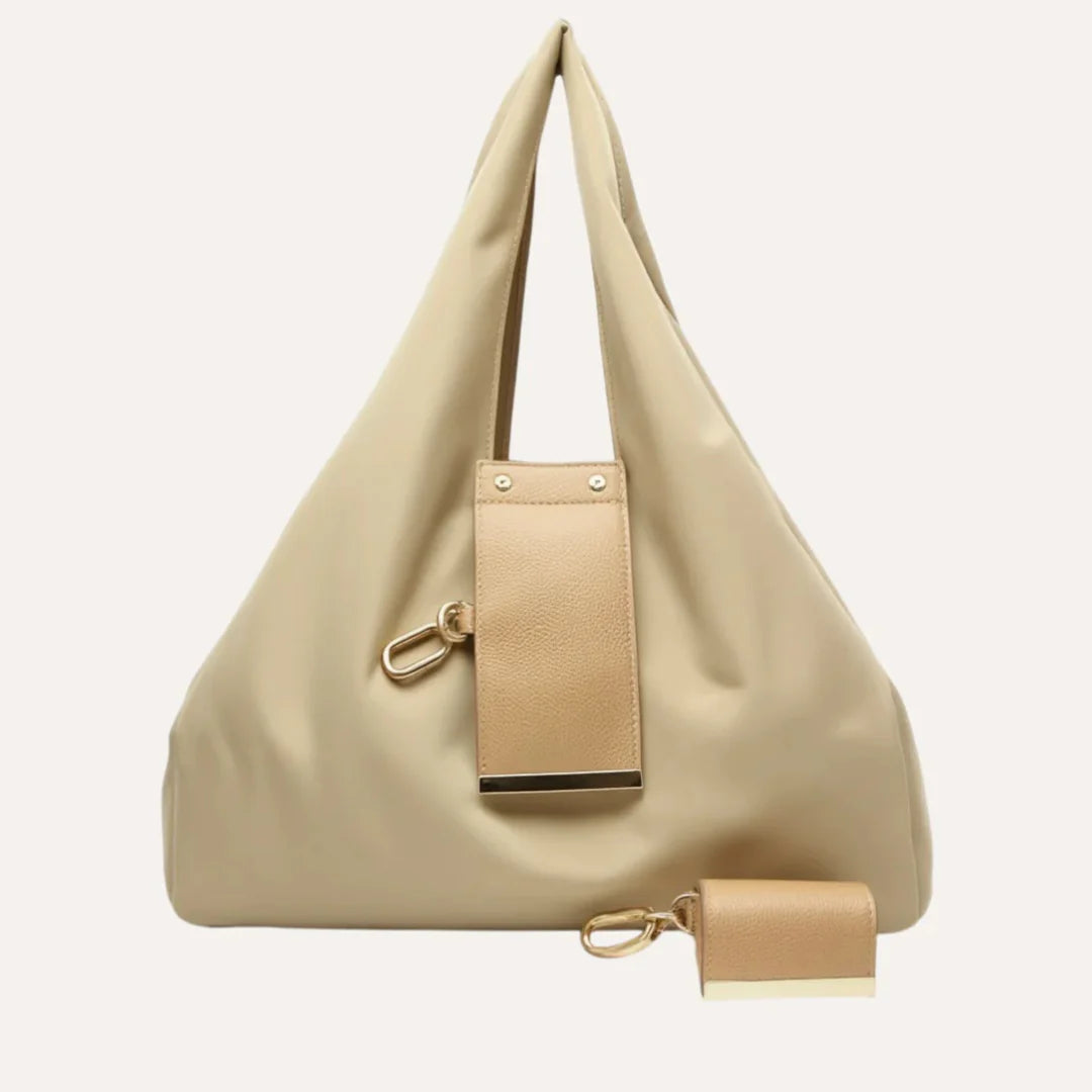 Beige handbag with matching pouch on a light beige background