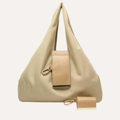 Beige handbag with matching pouch on a light beige background