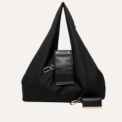 Black handbag with a smaller attached bag on a white background