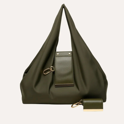 Green handbag with a matching keychain on a light gray background