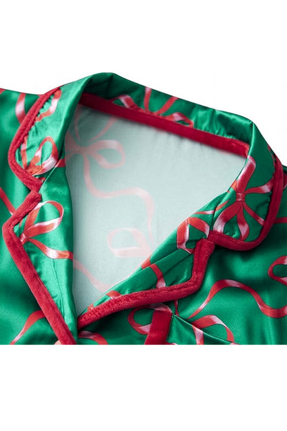 Green satin robe with red ribbons on a white background