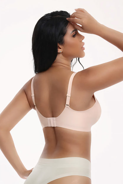 Woman wearing a beige bra and underwear set on a white background