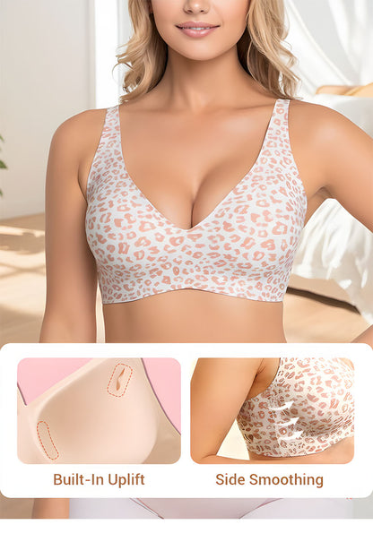 Woman wearing a patterned bra with built-in uplift and side smoothing features.