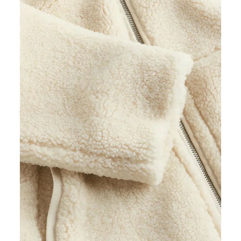 Close-up of a beige fleece jacket with a zipper