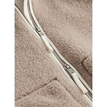 Close-up of a beige fleece jacket with a zipper