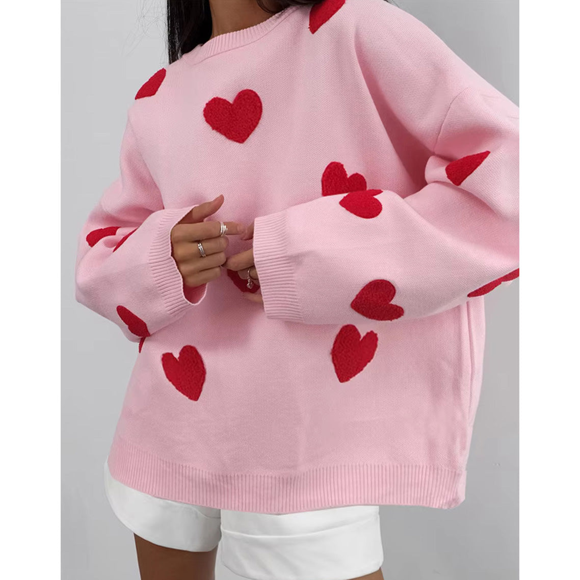 valentine heart sweater-jumper-heartshape-love sweater-pink-background-back hold-arms-red hearts-pink sweater